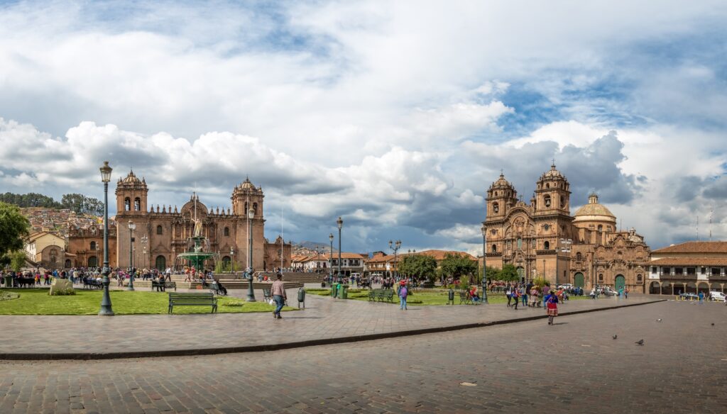 Plaza de Armas with Inca fountain, Cathedral and Compania de Jesus Church - Cusco, Peru